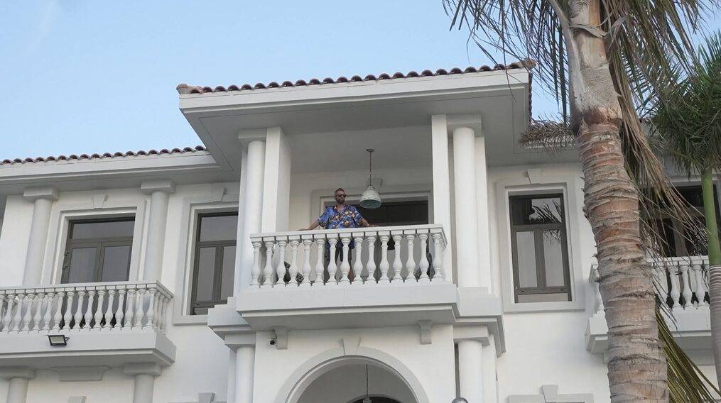 Adeel Chowdhry looking out of his mansion's balcony